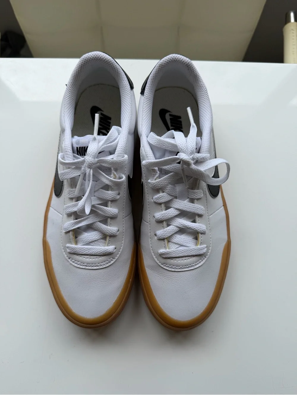 Nike White Leather Sneakers with Black Swoosh and Gum Sole